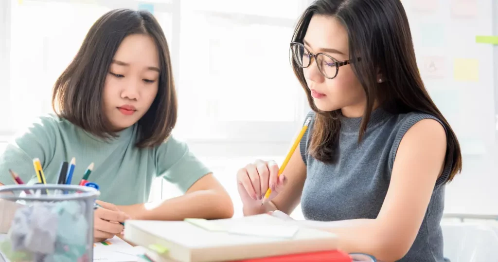 two people working on their homework | tuitioncentre sg
