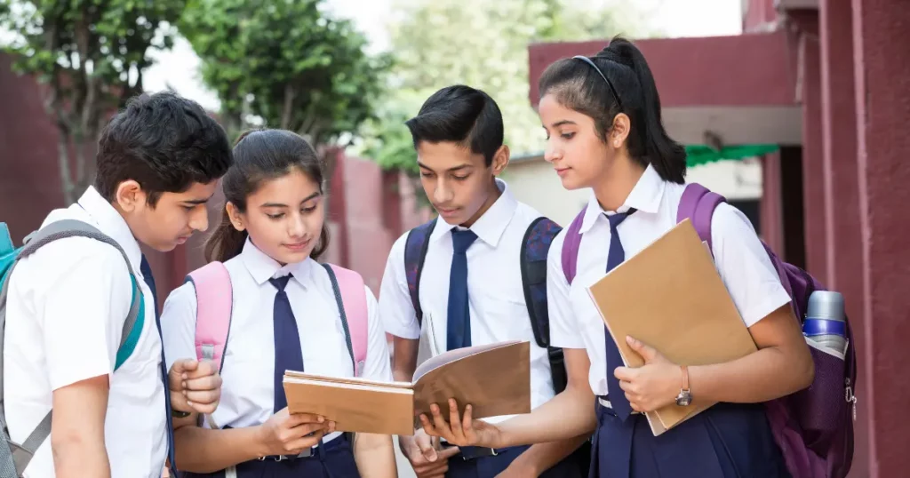 a group of school students standing in front of a building | tuitioncentre sg
