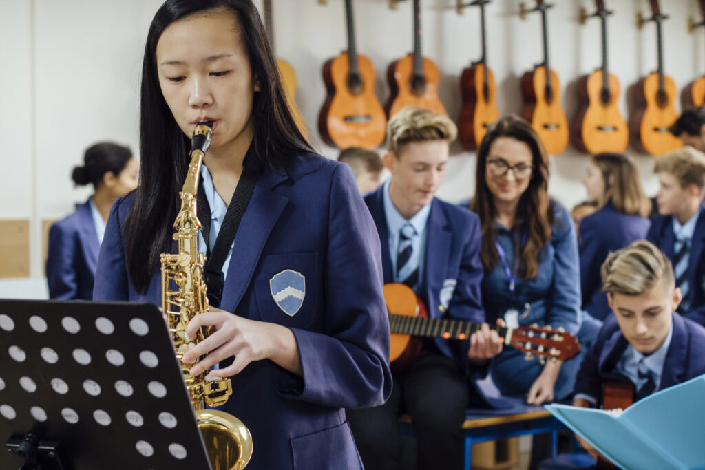 asian Secondary student playing Trumpet in classroom | Tuition Centre SG