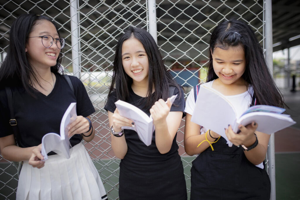 asian secondary student reading books at school | Tuition Centre SG