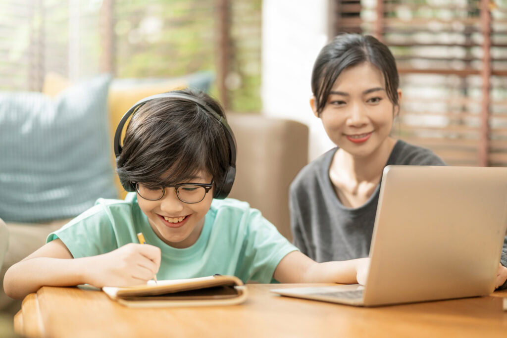 Cheerful asian child boy online lesson study from home | Tuition Centre SG