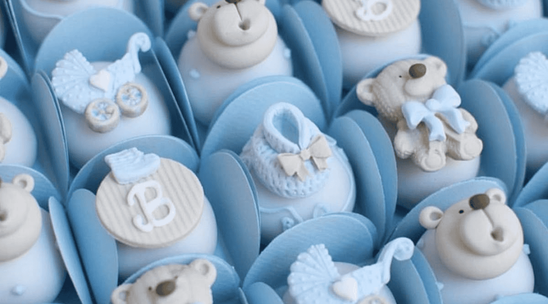 Adorable baby shower cupcakes featuring teddy bears, baby shoes, and monograms in soft blue colors.