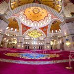 Interior view of Sheikh Zayed Grand Mosque in Fujairah with ornate domes and intricate designs.