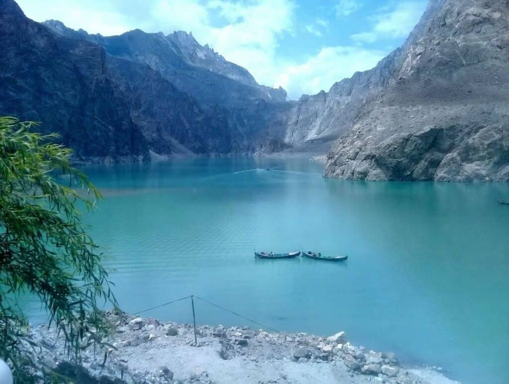 Beautiful mountain lake with turquoise waters and surrounding cliffs in Pakistan.