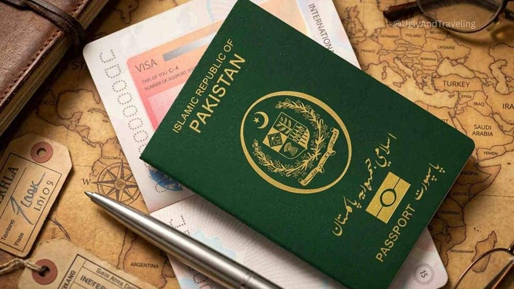 Pakistani e-passport with visa and travel documents on a table.