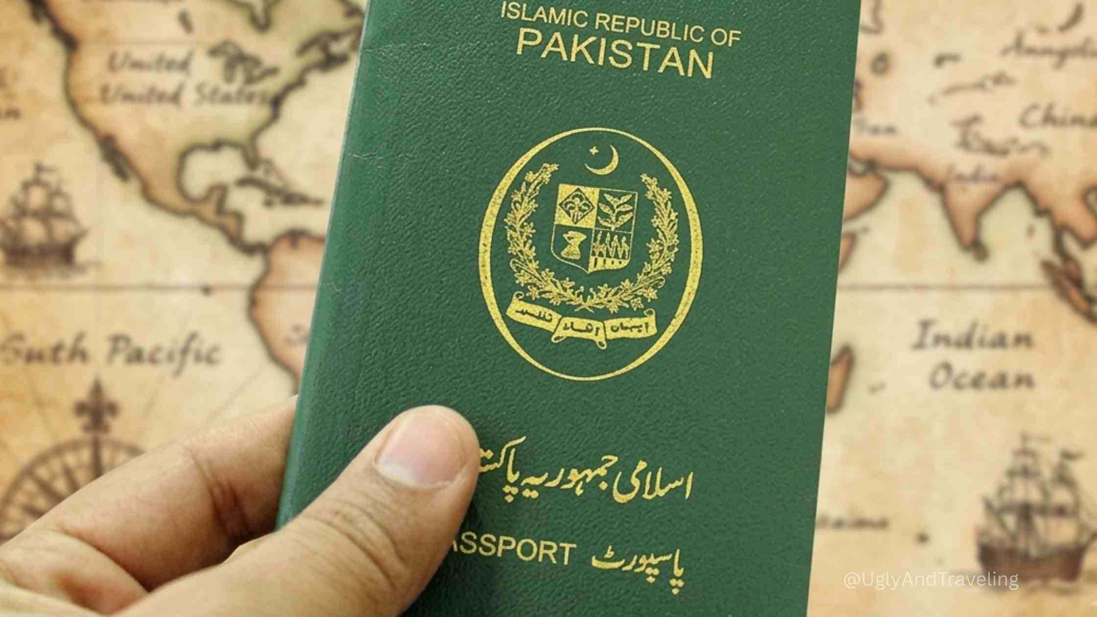 Pakistani passport with national emblem and green cover held in hand.