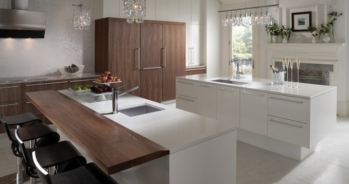 Contemporary white kitchen with wooden accents and ample natural light.