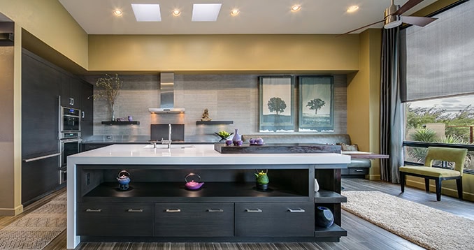 Urban Homes kitchen with spacious island and large windows, blending modern design with natural ligh.