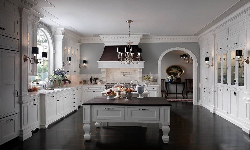 Elegant white kitchen featuring classic cabinetry and a central island for modern urban homes.