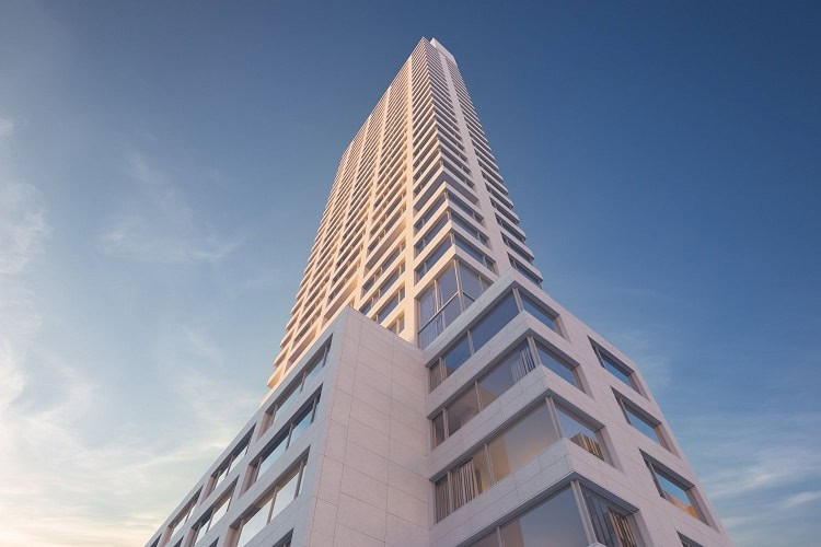 Modern high-rise apartment building in a city skyline with contemporary architecture.