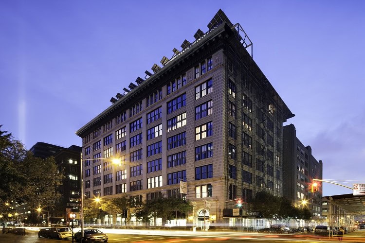 Urban residential building in downtown cityscape at dusk.