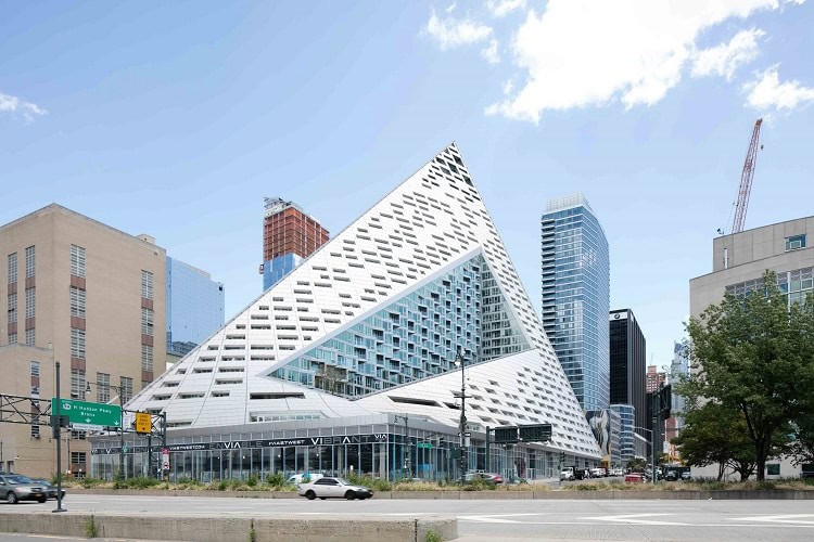 Urban Homes modern building with unique geometric design in a cityscape.