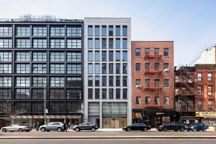 Contemporary urban homes with diverse architectural styles in a cityscape.