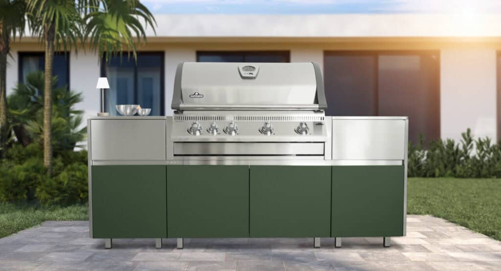 Outdoor kitchen featuring a modern stainless steel grill and ample counter space for cooking and ent.