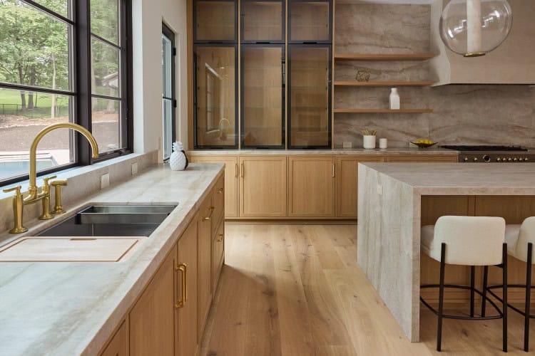 Elegant transitional kitchen with natural wood cabinets and large windows in Tenafly, NJ.