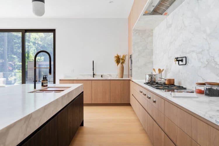 Urban Homes modern kitchen with sleek design and large window for natural lighting.