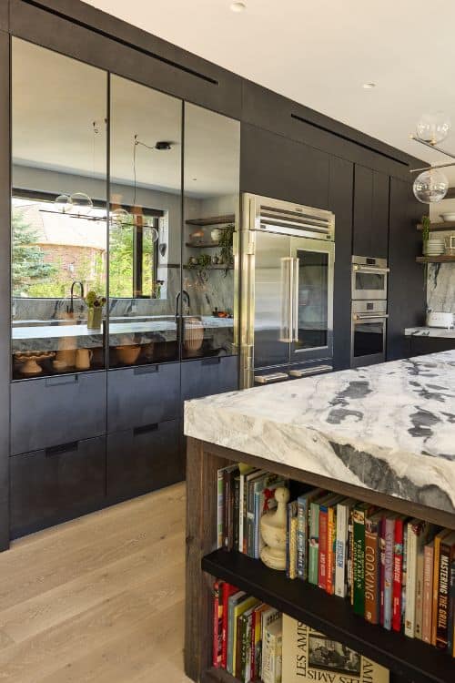 Modern farmhouse kitchen with sleek black cabinetry and marble countertops in northern New Jersey.