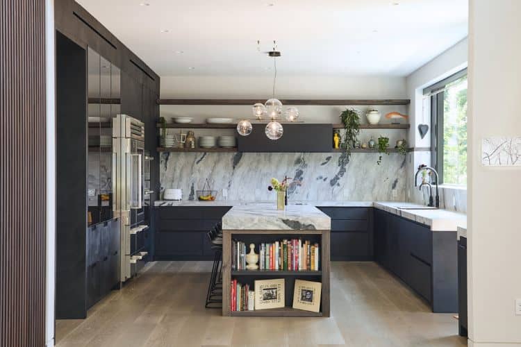Bright modern farmhouse kitchen with navy cabinets and marble countertops in northern New Jersey.