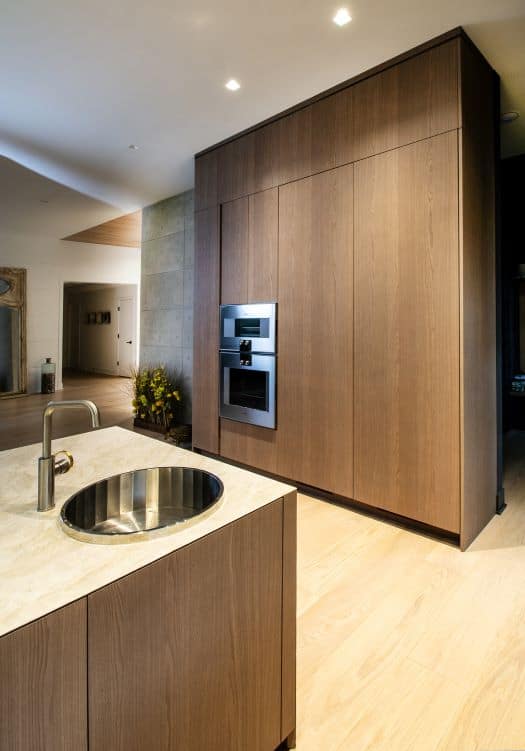 Custom kitchen design with sleek wood cabinetry and modern appliances.