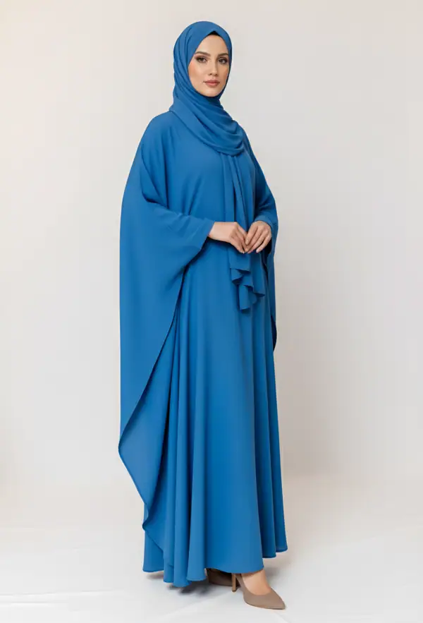 Woman wearing a blue abaya and matching hijab, full-length modest fashion outfit.