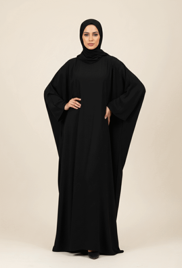 Elegant woman in black abaya and hijab, showcasing modest fashion from Umeed Designs.