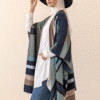 Elegant woman wearing a stylish wide-brim hat, hijab, and fashionable layered outfit for summer or c.