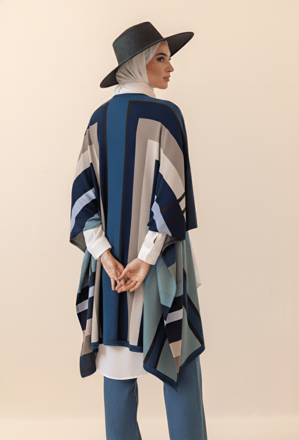 Elegant woman wearing a stylish geometric patterned shawl and wide-brim hat, showcasing Umeed Design.