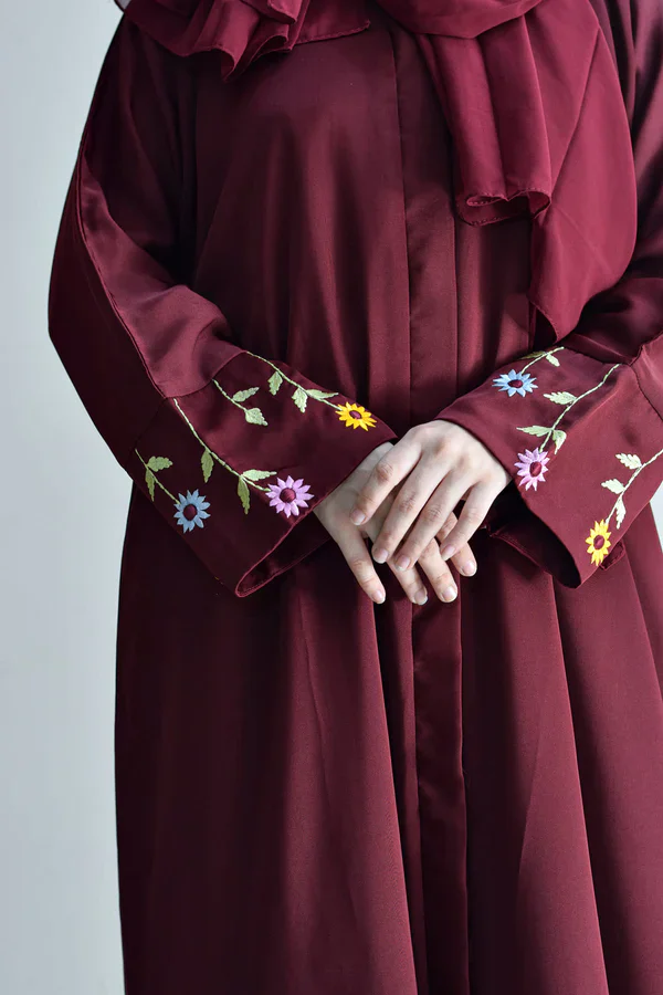 Embroidered maroon dress with floral patterns on sleeves, elegant and stylish for special occasions.