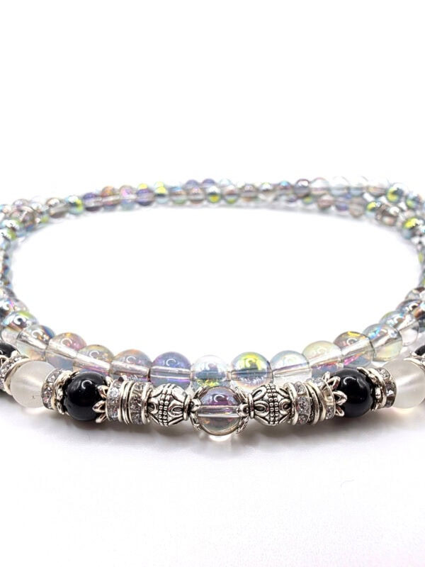 Elegant beaded jewelry with silver accents, black and iridescent beads, perfect for stylish accessor.