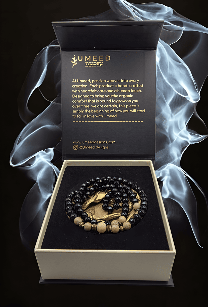 Elegant jewelry gift set with black and gold beads, presented in a stylish box with a Umeed Designs.