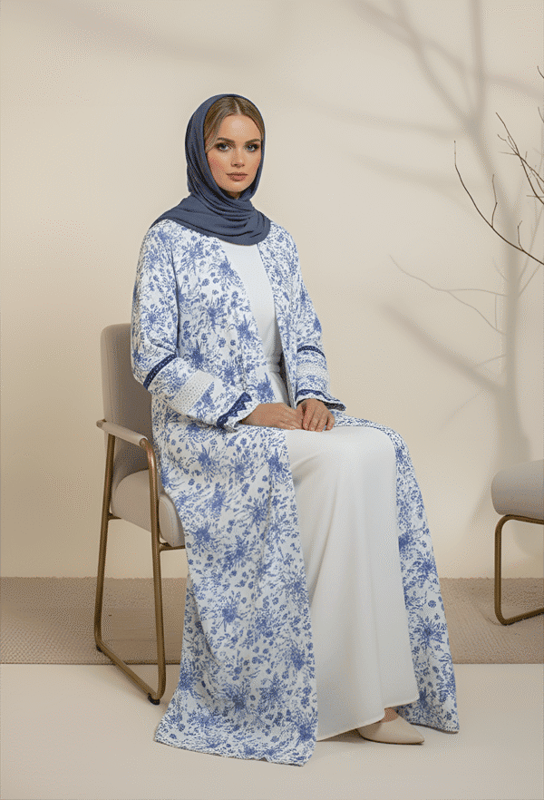 Beautiful woman wearing traditional blue and white embroidered abaya with a matching hijab for modest fashion.