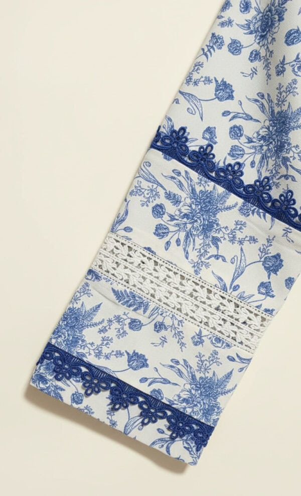 Beautiful blue and white floral fabric featuring lace details, perfect for elegant traditional garme.