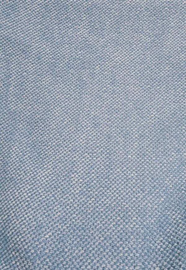 Blue textured fabric with a detailed woven pattern, ideal for upholstery or fashion design.
