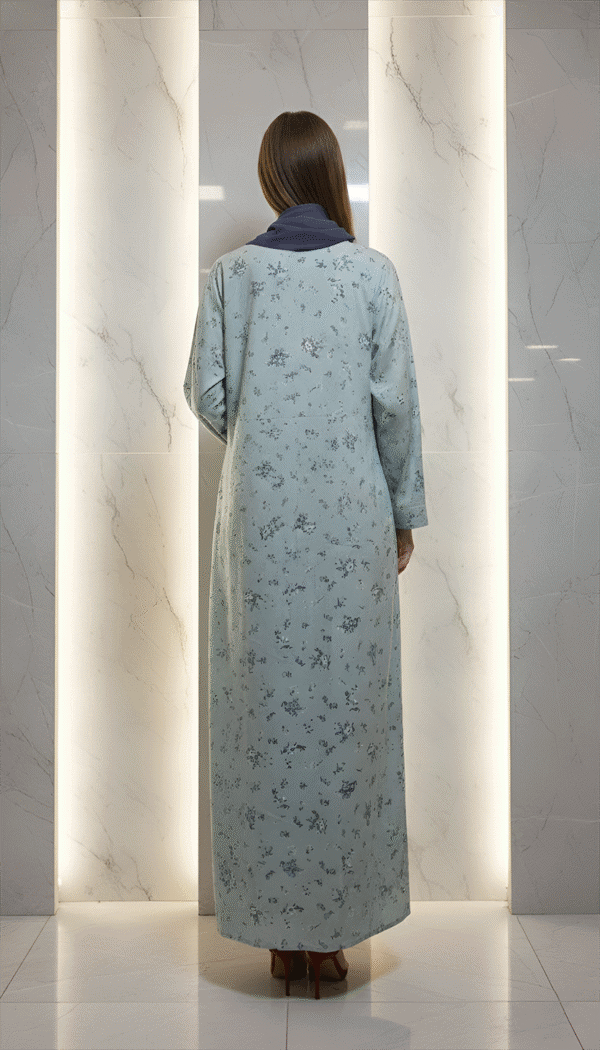 Elegant woman wearing a light blue embroidered traditional dress at Umeed Designs.