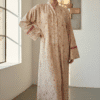 Woman wearing a beige floral maxi dress with long sleeves and a high neckline.