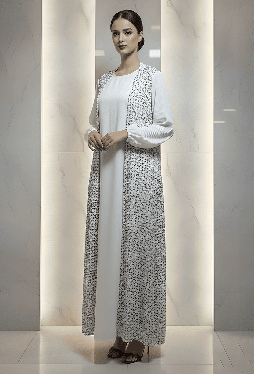 Woman wearing a stylish white abaya with intricate embroidery, standing confidently indoors.
