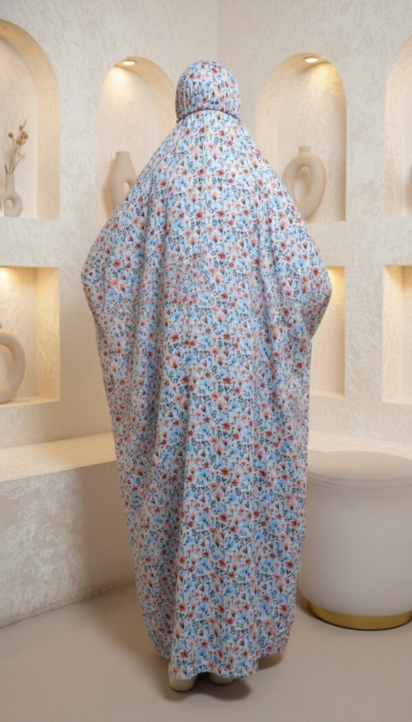 Elegant floral abaya with matching hijab, displayed in a modern, minimalist setting. Perfect for mod.
