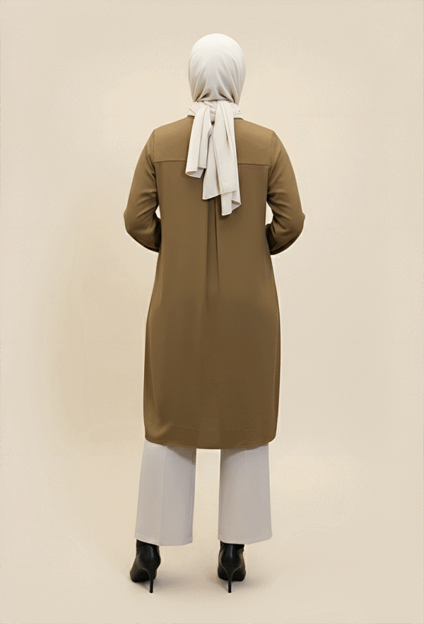 Modest women's fashion featuring a beige long coat, white wide-leg pants, and a white hijab.
