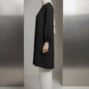 Elegant modest black dress with white pants and hijab, showcasing contemporary Islamic fashion.