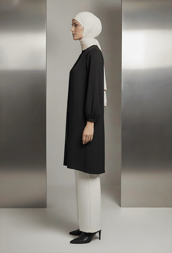 Elegant modest black dress with white pants and hijab, showcasing contemporary Islamic fashion.