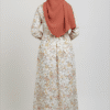 Elegant floral maxi dress paired with a rust-colored hijab for modest fashion.