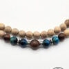 Beaded handmade necklace with wooden and blue glass beads, crafted by Umeed Designs.