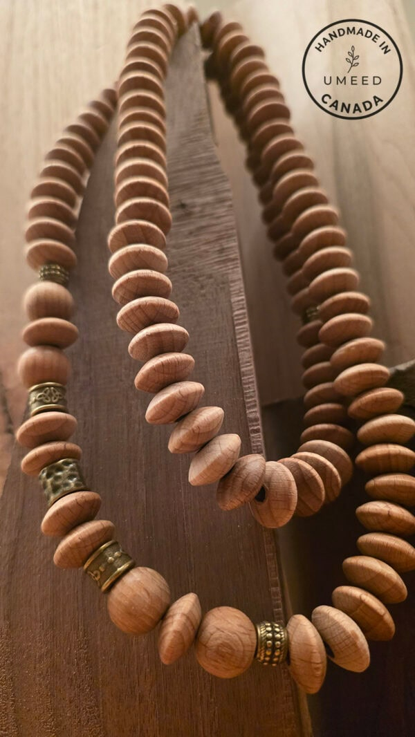 Handmade wooden beaded necklace with natural wood tones and gold accents, crafted by Umeed Designs i.