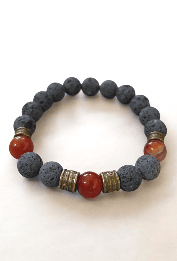 Bracelet featuring black lava beads and red accents, handcrafted jewelry by Umeed Designs.