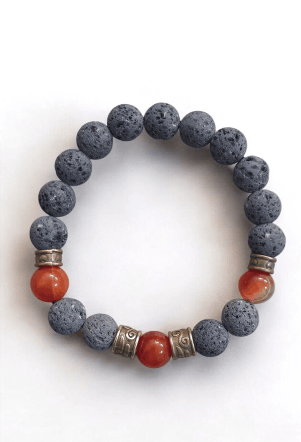 Bracelet featuring volcanic lava beads and vibrant coral accents with metallic spacers.