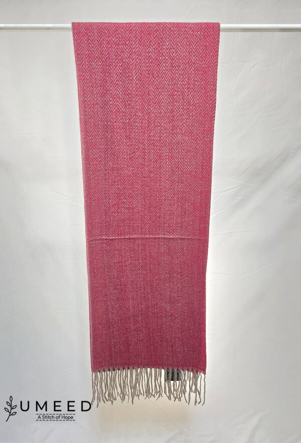 Pink handwoven scarf with intricate patterns, showcasing craftsmanship and vibrant color.