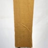 Handwoven mustard yellow scarf with fringe detail, displayed on a white background.