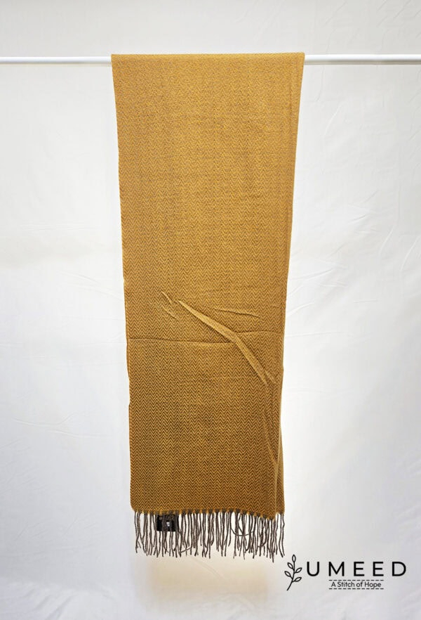 Handwoven mustard yellow scarf with fringe detail, displayed on a white background.