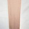 Handwoven peach scarf with intricate patterns, perfect for stylish accessories.