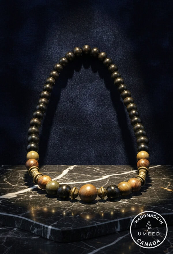 Elegant wooden beaded necklace with mixed natural tones and brass accents. Perfect for boho or casua.